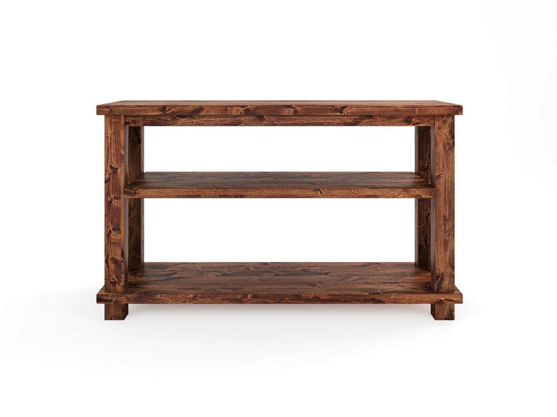 The Carter X Sofa Table - Tuscany by James+James features a rectangular wooden top, two spacious shelves underneath, and a rich, dark brown finish. The table's sturdy, block-like legs complement its simple and functional design, making it ideal for storage or display in a variety of settings.