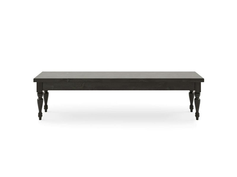 The Chateau Bench - Charred Ember by James & James is a long, rectangular black table with a smooth top and four intricately carved legs, set against a plain white background.