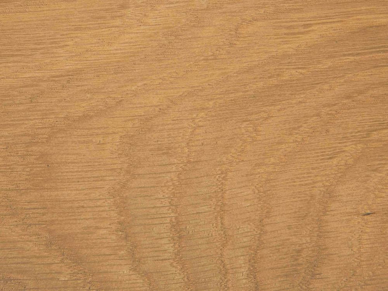 A close-up view of the James+James Satin on White Oak Sample showcasing a natural grain pattern with wavy lines and varying shades of light brown.