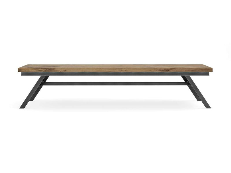 The Fulton Bench - Harvest Wheat by James+James features a rectangular wooden top with a rustic finish and black metal legs. This minimalist piece includes a flat top and angled legs connected by a horizontal support bar. The visible wood grain adds a natural touch to the design.