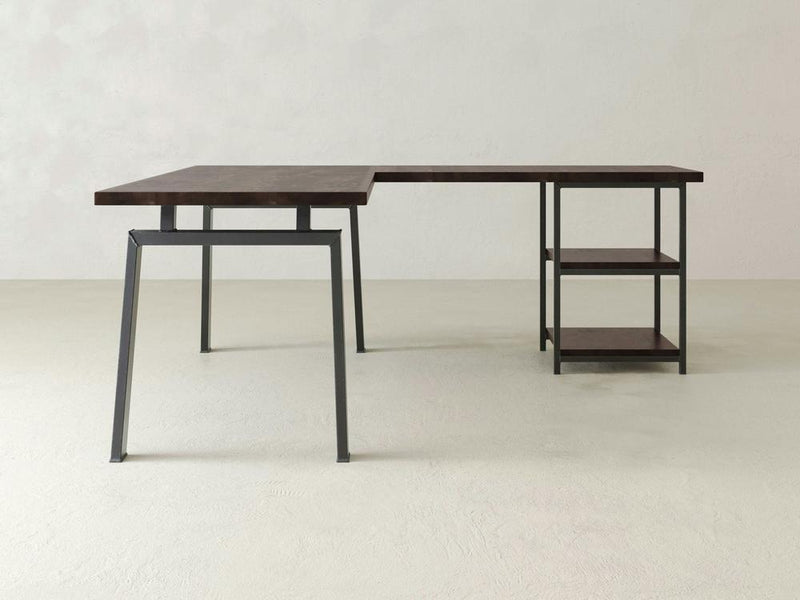 The Fulton Corner Desk by James & James features an L-shaped design with a tobacco wood finish and black metal frame, complemented by open shelving on one side and a spacious desktop.