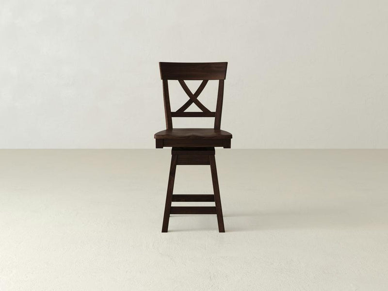 The Juniper Swivel Stool by James & James, made from maple hardwood, features a high X-back design, circular seat, and four sturdy legs with a footrest. Set against a plain white background, it combines comfort and style in a functional and striking piece.
