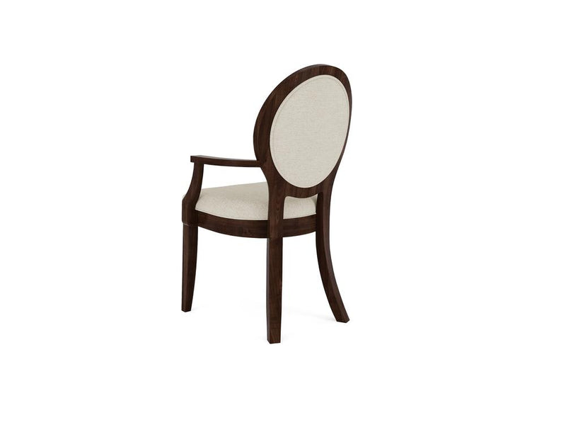 Wooden chair with an oval backrest and curved arms, featuring beige upholstered seat and back. The dark brown wood frame has a classic design with elegantly splayed legs. The chair is angled slightly to the left.