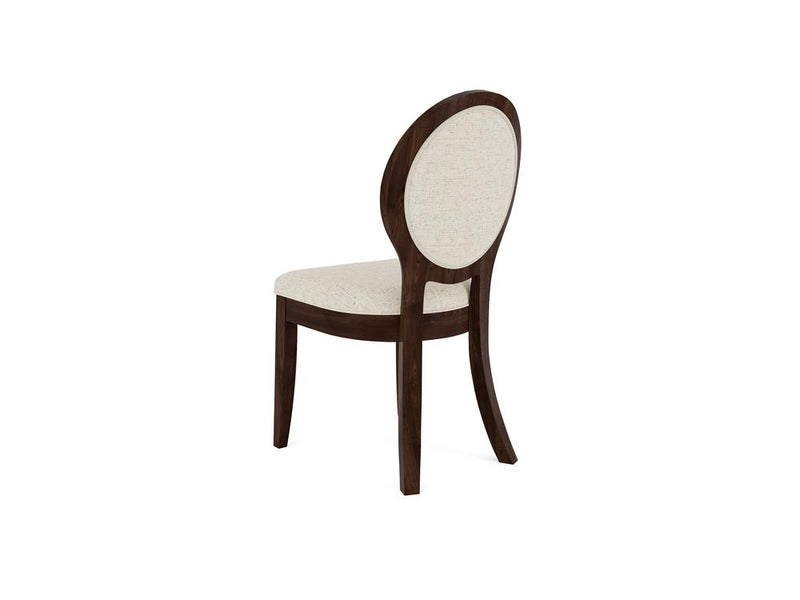 A wooden chair with a dark brown frame and a light beige cushioned oval backrest and seat. The chair is positioned with its back facing the viewer, showcasing its elegant design and curved legs.