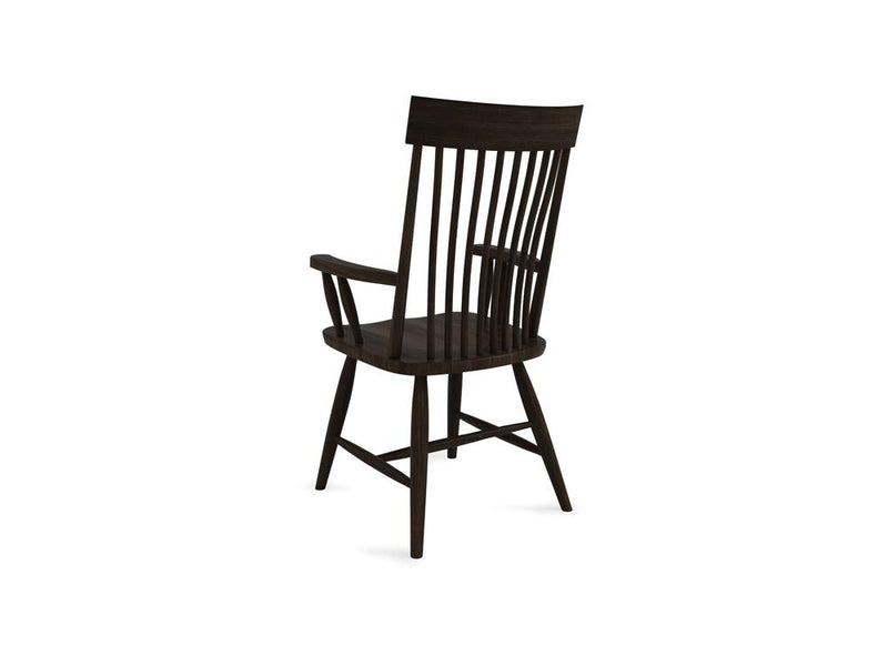 A dark wooden armchair with a high, vertical slatted back. The chair has curved armrests and a slightly angled seat. The design is simple and traditional, highlighting the natural wood grain.