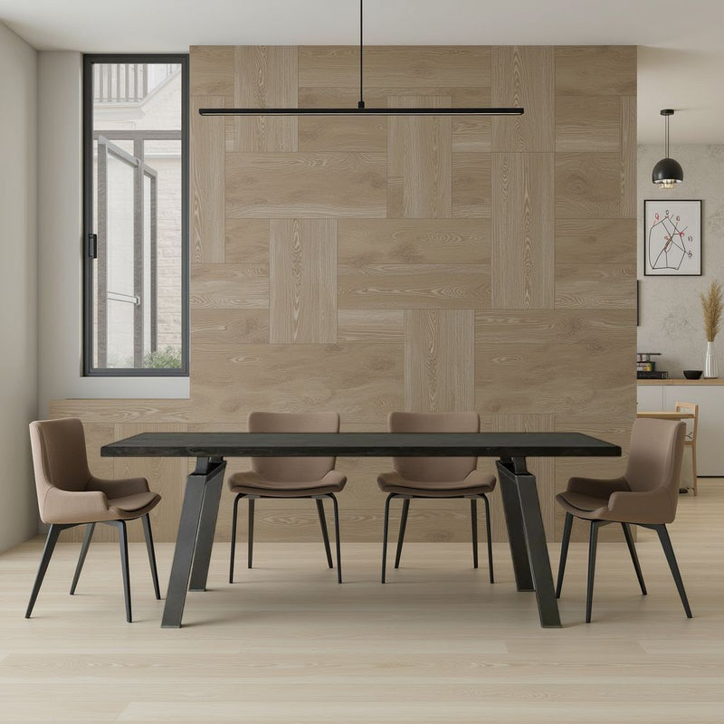 Minimalist dining room with the Fulton Dining Table - Charred Ember by James+James, five beige chairs, light wood floors, and a wood-paneled accent wall. A large window, modern light fixture, and part of a kitchen appear in the background.