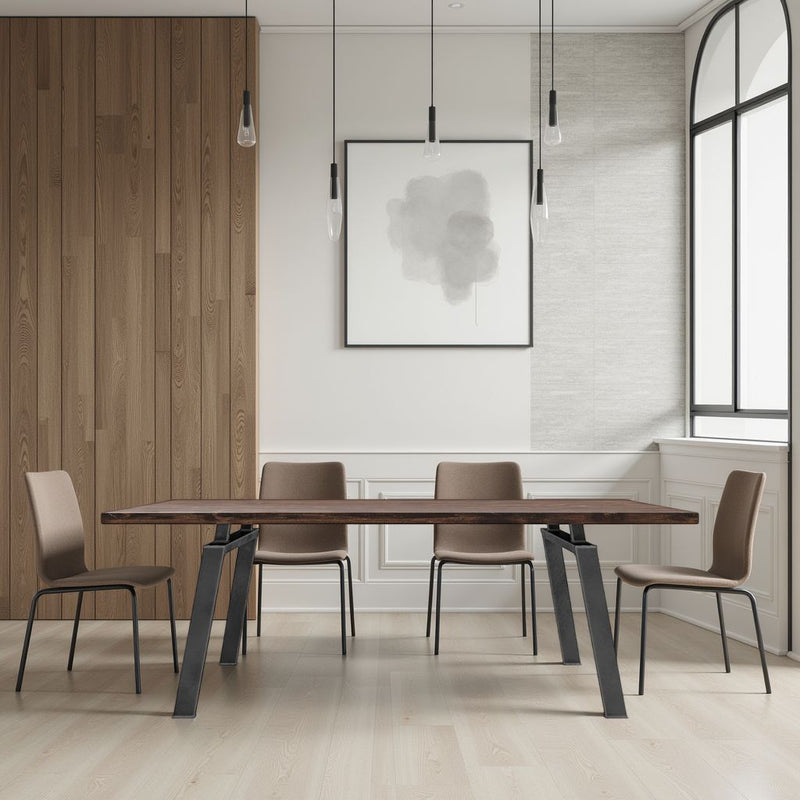 A minimalist dining room features the Fulton Dining Table - Tobacco by James+James, four brown chairs, modern pendant lights, a large window, wood-paneled wall, and abstract art. Natural light brightens the clean, inviting space.