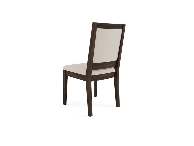 A wooden chair with a dark brown frame and a light beige upholstered seat and backrest, viewed from the back at a slight angle. The chair has a simple and modern design with clean lines.