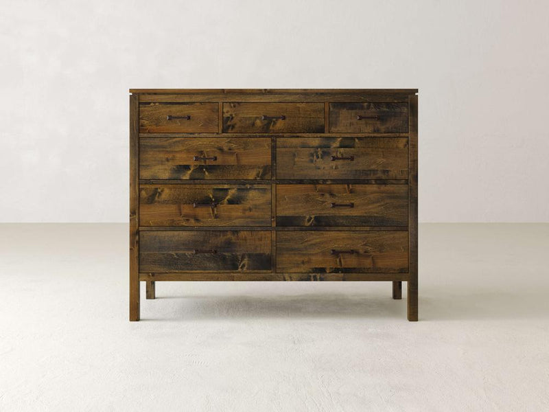 The James & James Jensen 9 Drawer Dresser radiates rustic charm with its maple hardwood build. Its nine drawers, arranged neatly in three rows, feature simple handles and a natural textured finish that complements any modern design against a plain white background.