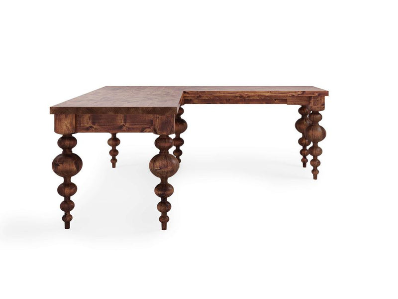 Introducing the Olivia Corner Desk - Tuscany by James+James; this wooden L-shaped desk features intricately carved, rounded legs and a rustic finish. It offers ample workspace with a right-angle extension, making it ideal for various tasks and decorative styles. The smooth, polished surface ensures a refined look and feel.