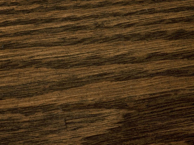 Close-up of the James+James Charred Ember on White Oak Sample, showcasing a rich, dark brown color with visible horizontal grain patterns. The texture features subtle color variations, enhancing the natural appearance of the wood.
