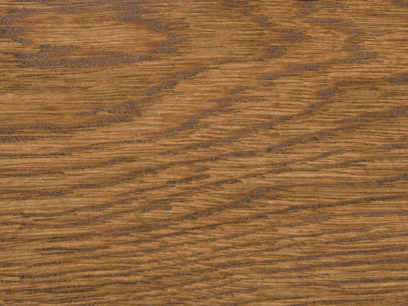 A close-up view of the Tuscany on White Oak Sample by James+James reveals a beautifully warm brown finish. The wood grain stands out prominently, displaying a mixture of straight and wavy lines in an array of brown shades, resulting in a natural and textured pattern.