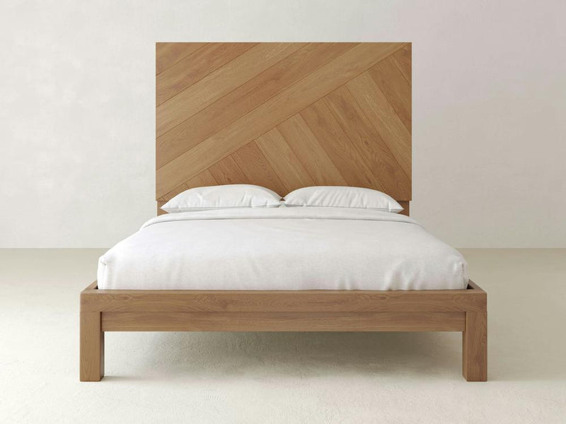 A close-up view of Luna - Satin wooden planks from James+James laid diagonally. The wood features a natural, light brown color with visible grain patterns and texture. The image highlights the variations in the wood grain and the subtle shifts in color and tone.