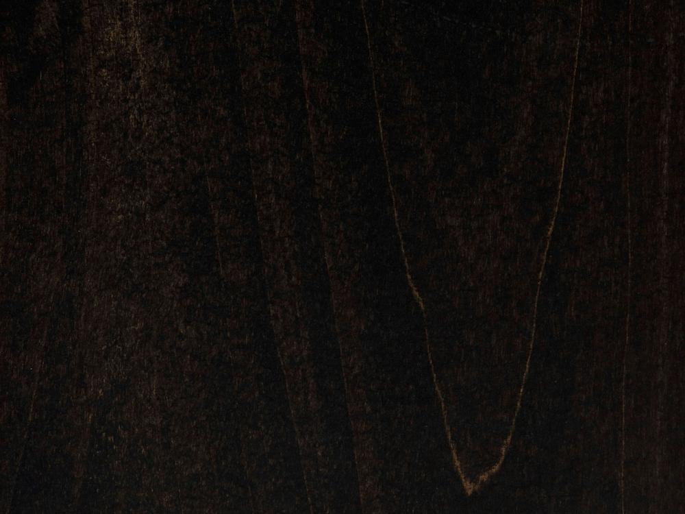 A close-up of the textured surface of the "Abigail Coffee Table - Charred Ember" by James+James showcases deep, rich brown to almost black hues, with faint, irregular lines and shading variations that give it a slightly uneven but natural appearance.