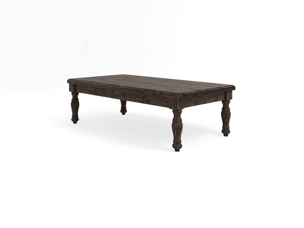The Abigail Coffee Table from James+James features a dark tobacco finish. This wooden, rectangular table boasts a plank-style top and stands on four intricately carved legs, imparting a rustic yet classic look. The table is showcased against a plain white background.